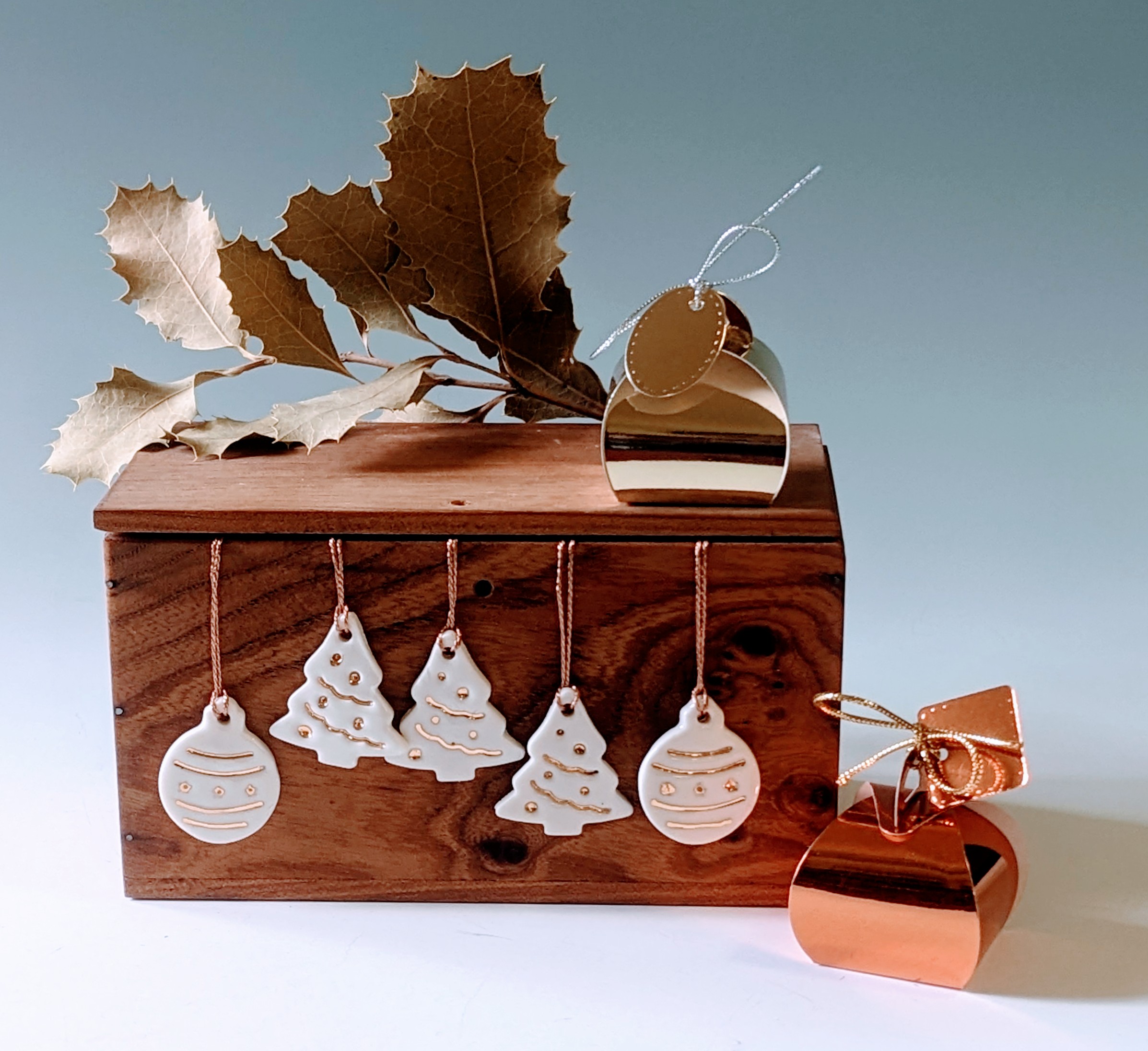 ceramic Christmas decorations on a wooden display